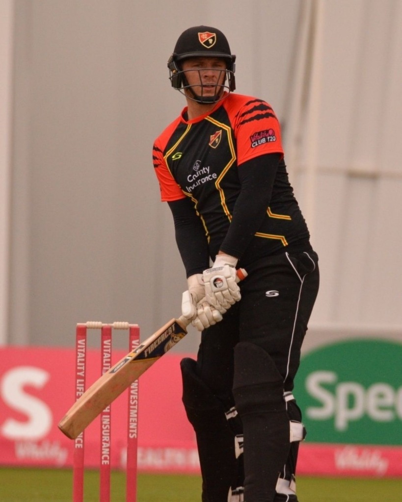 Cricket player preparing to swing his bat